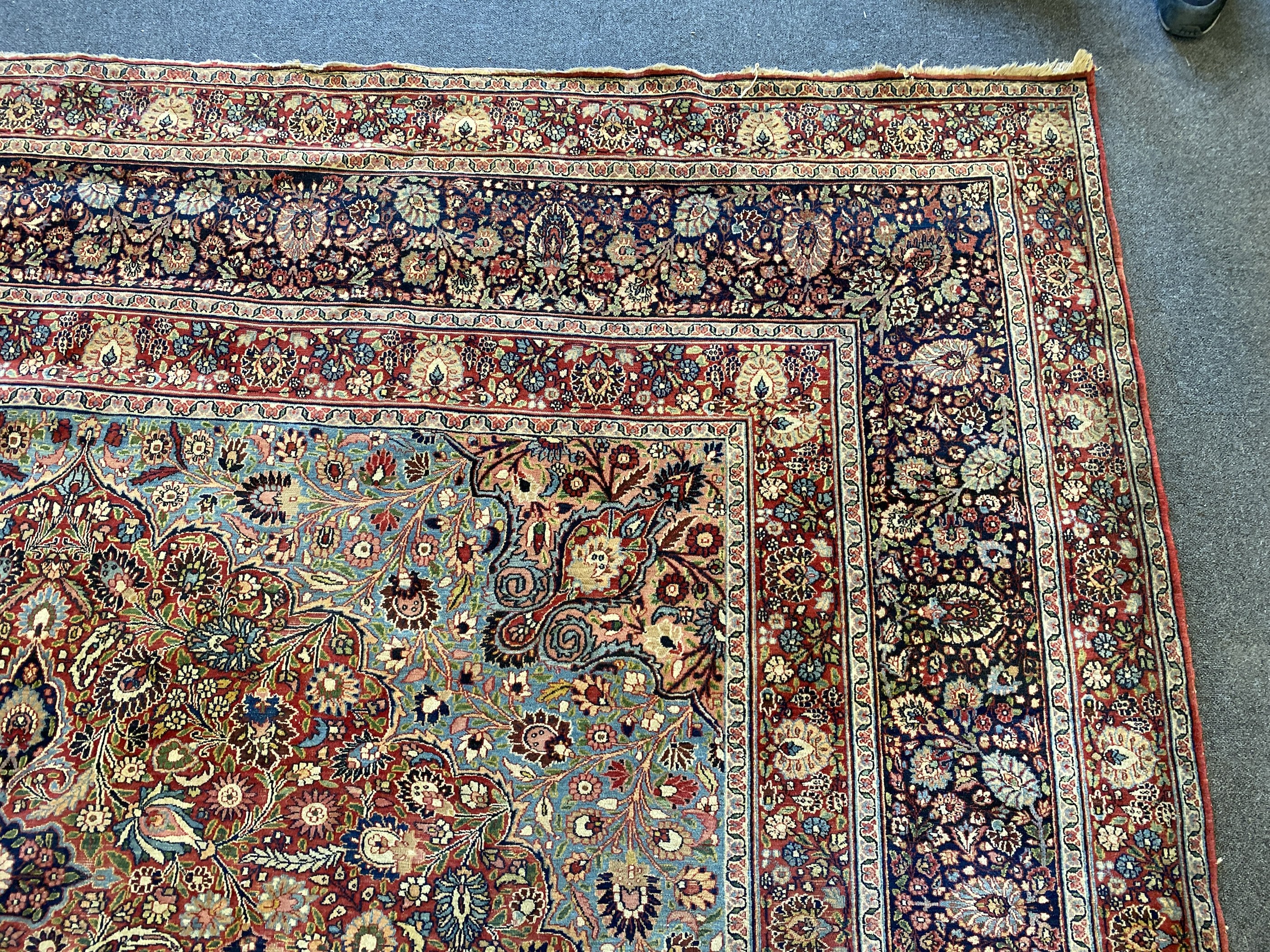 A large Persian blue ground carpet, 395 x 305cm